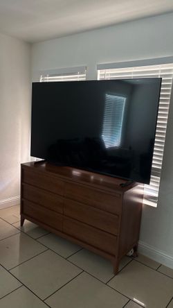 Samsung 75 inch tv with the cabinet, the speaker bar and subwoofer.