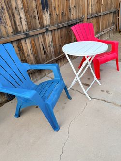 Set of 2 chairs with polypropylene frames and a 2.6 ft round folding table.