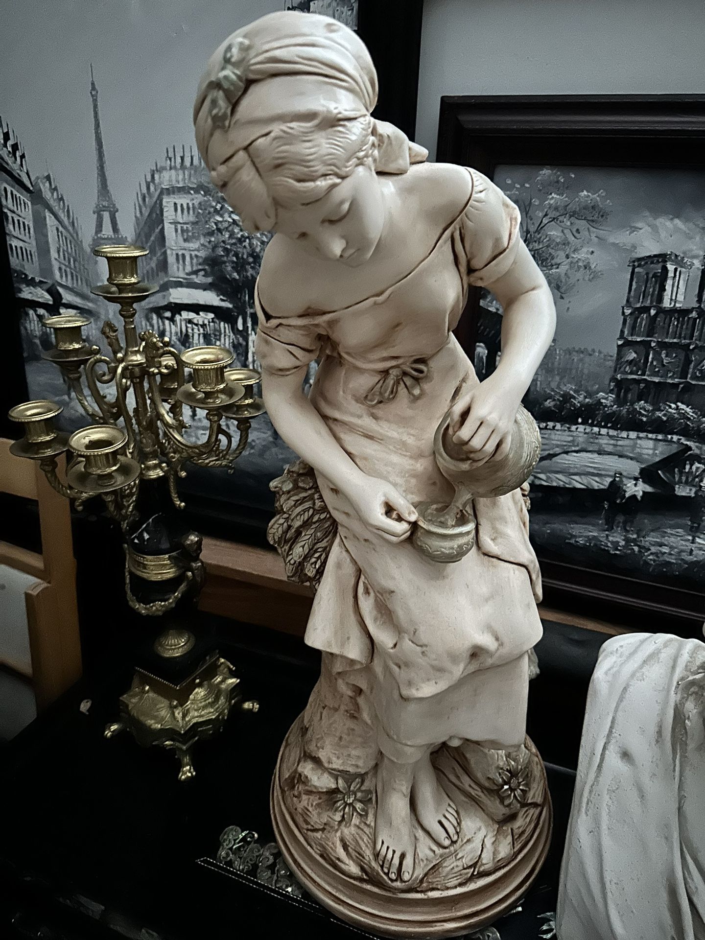 Sculpture Of Woman Gathering Water