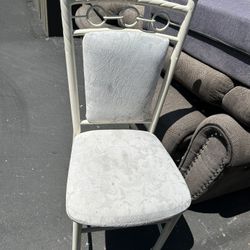 White-painted metal frame chair with white fabric upholstered back and seat.