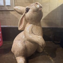 Adorable ceramic rabbit figurine, glossy fawn color, long ears, fun expression