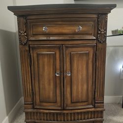 Dark wood cabinet w/ granite top
