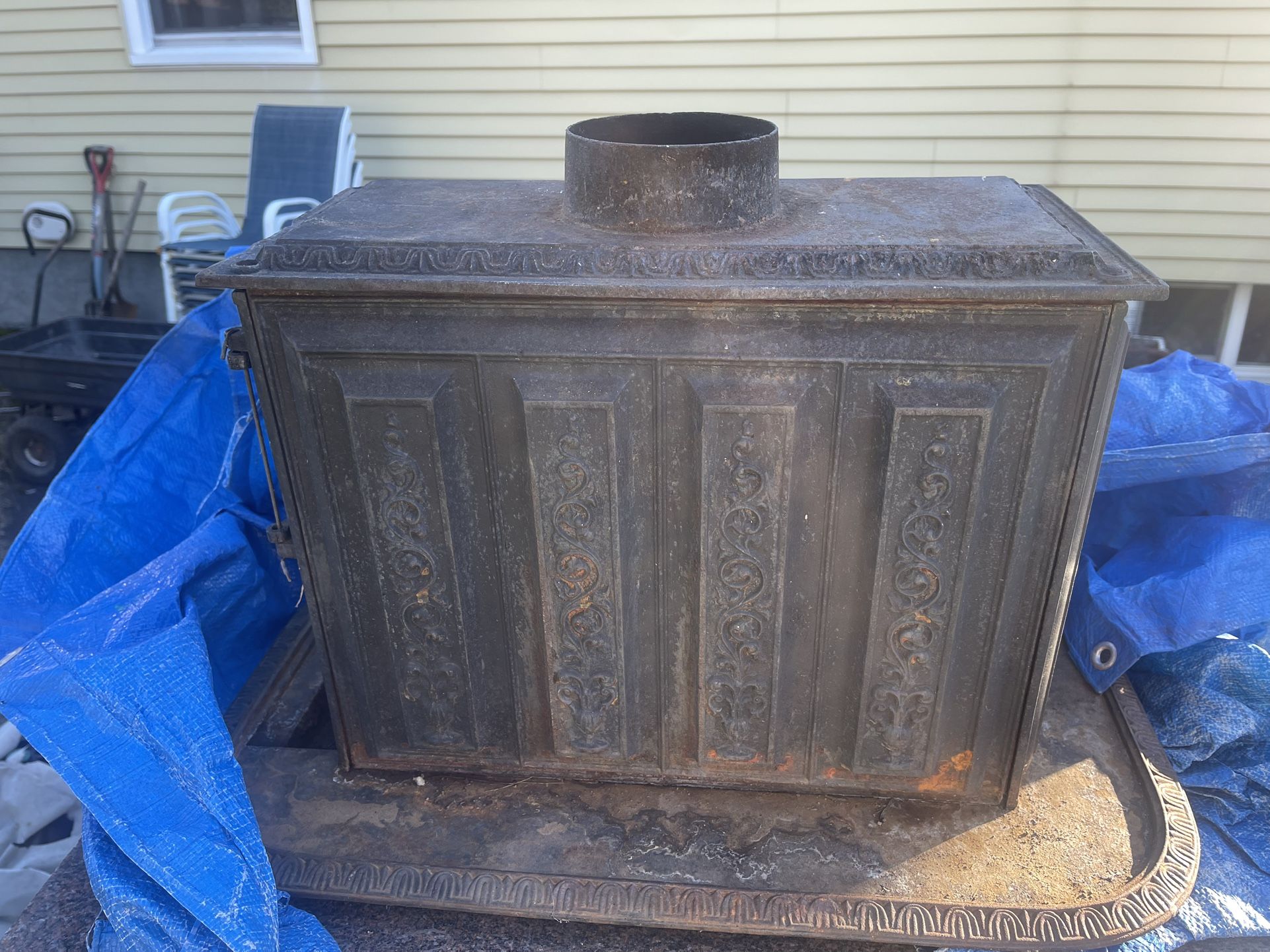 An Antique Small Cast-Iron Fireplace Wood-Burning Stove