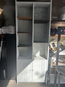 White shelving unit with bottom cabinets