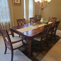 Dining room table, chairs and curio
