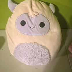 Squishmallows plush toy Ronalda the Yeti. She is a pastel pink yeti with a purple face, horns 