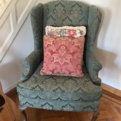Green Armchair With Embellished Pillows