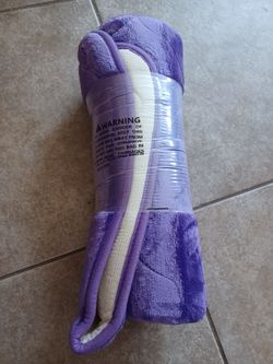 Purple Plush Soft bath mat brand new  
New purple plush blanket is made of a soft, fuzzy material with a white mesh-like underside.