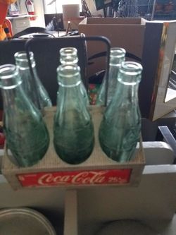 Vintage aluminum Coca Cola Caddy with assorted location bottles