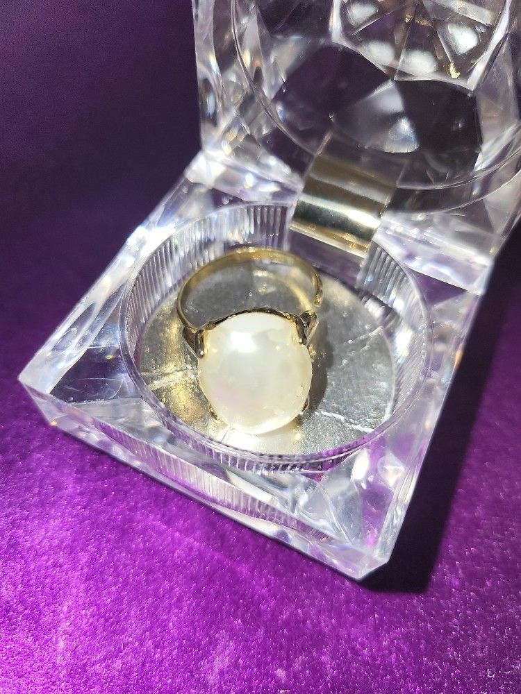 Adjustable Pearl (Faux) Ring. Stone has Some Slight Peeling that Exposes the Actual stone Underneath. Still very Pretty.