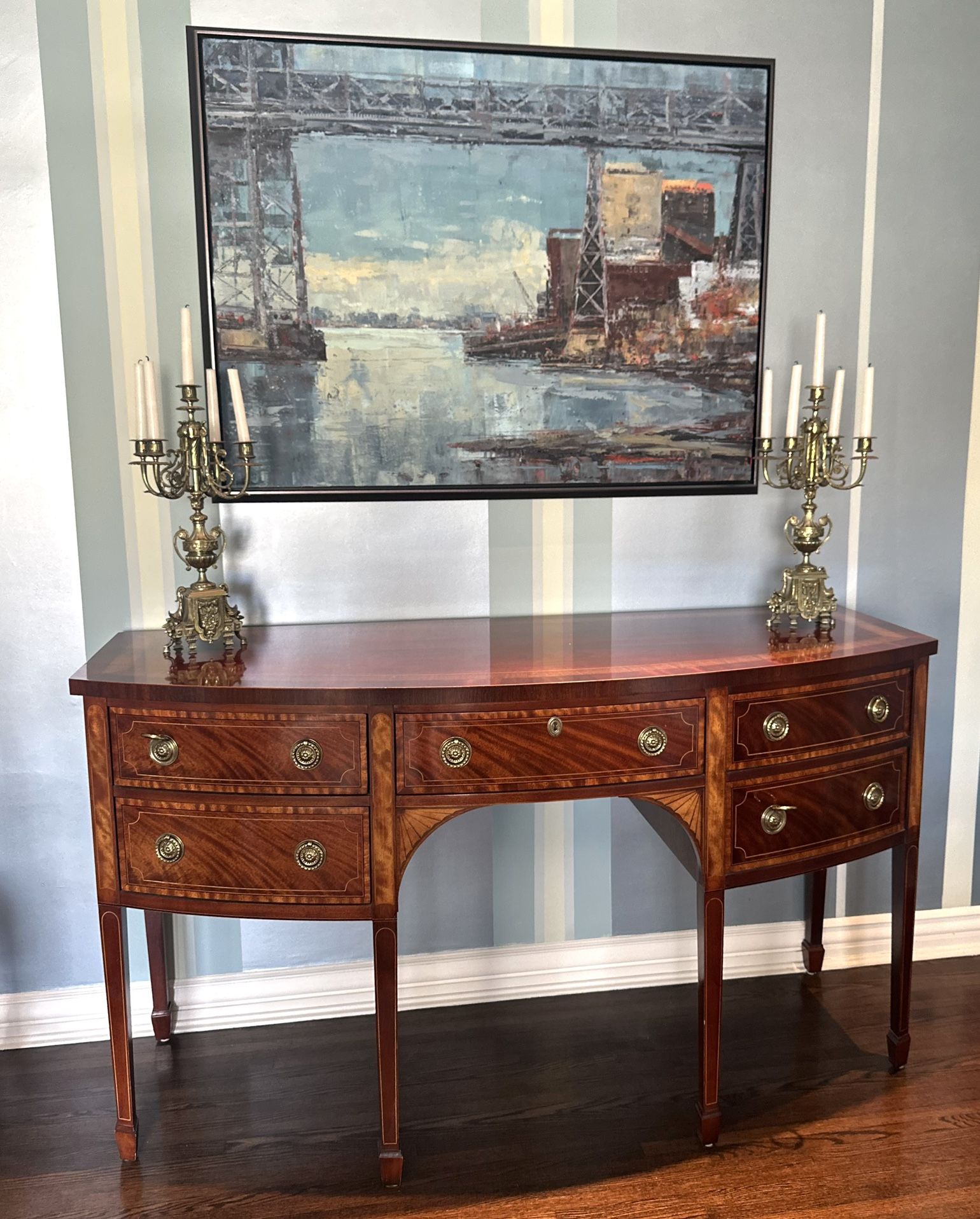Timeless elegance by Baker Furniture. This gorgeous bowfront mahogany chest features rich wood grain, banded inlay accents, and classic brass hardware