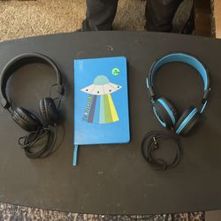 Two pairs of headphones and a journal