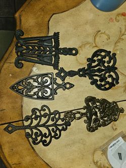 5 cast iron trivets $50