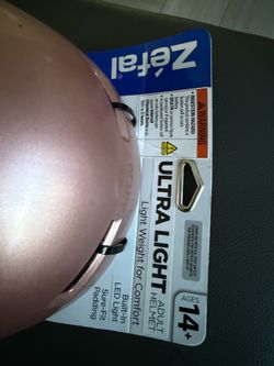 New Zéfal Ultra Light adult bicycle helmet in rose gold. This helmet has a built-in rear-facing LED light with multiple modes. It is designed for ages