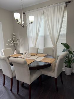 Adjustable dining table with storage cabinet.