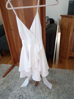 Versatile ,beautiful summer dress. Dress it up with heels and jewelry or dress it down w a  denim jacket.  Adjustable chriscross spaghetti straps high