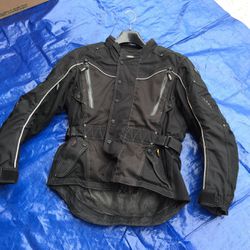 Motorcycle riding jacket with spine and elbow pads