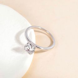Beautiful moissanite solitaire ring featuring a sparkling round-cut stone set in a timeless four-prong setting. The sleek silver band gives it a clean