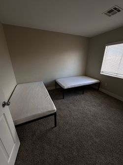 two black Twin size beds