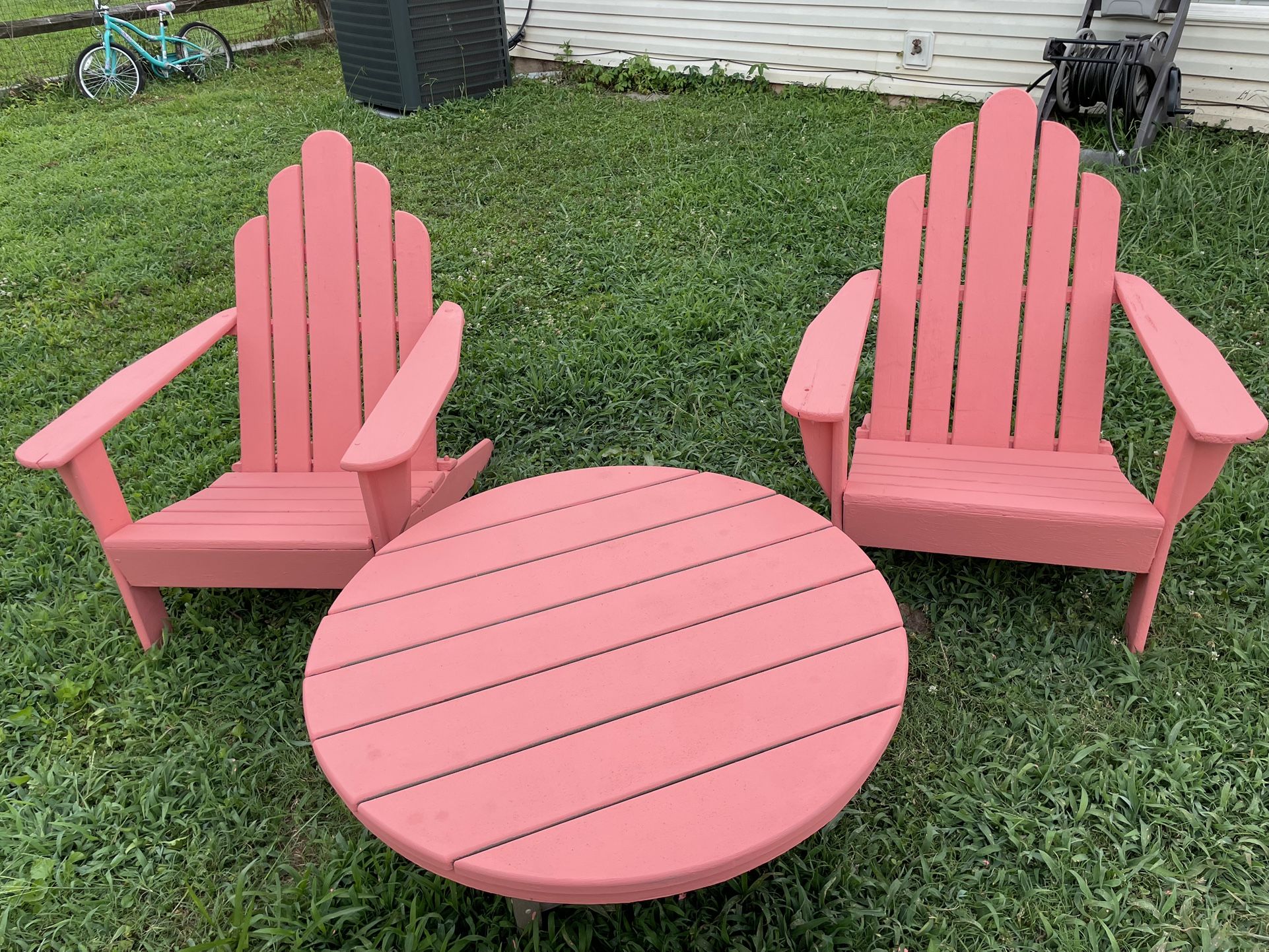 3 piece patio set. 2 wooden Adirondack chairs 1 composite wood table