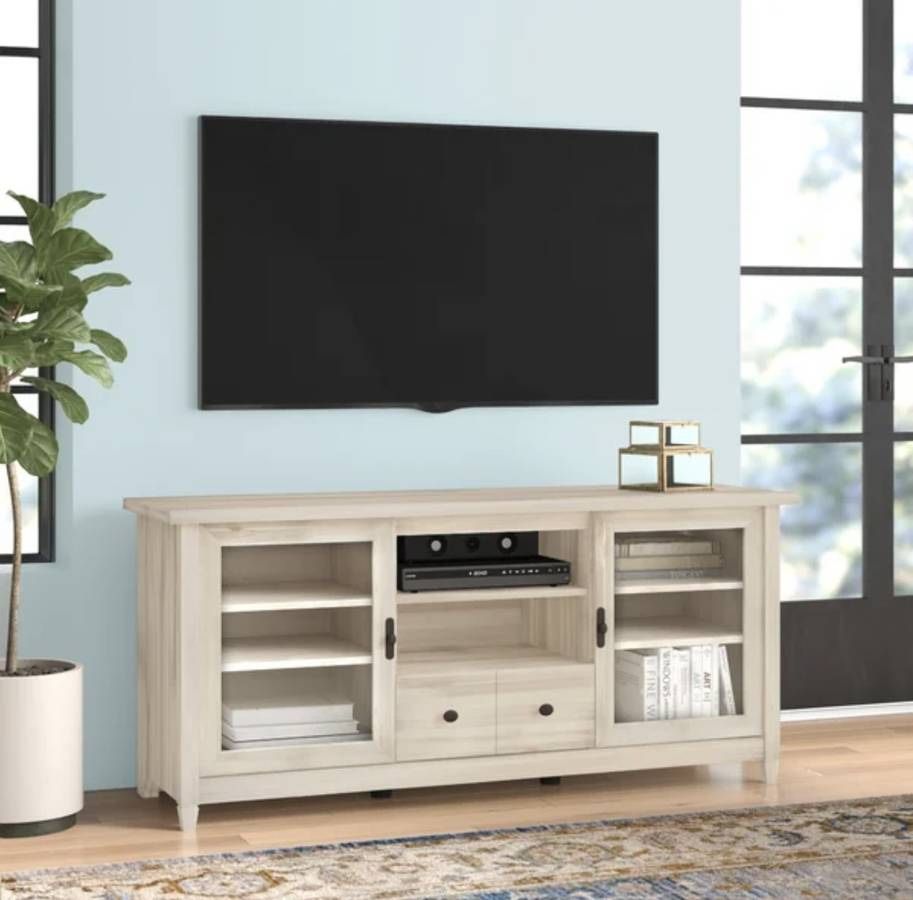 Tv Stand New in Packaging With Adjustable Shelves and Tempered Glass Doors Retailed For $419.12.