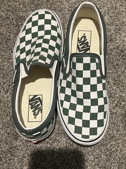 Green and white slip on Vans 