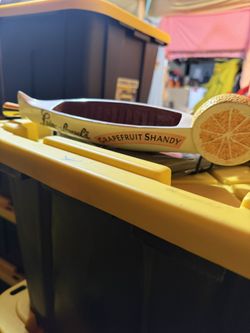 This is a Leinenkugel's Grapefruit Shandy beer tap handle, a collectible item for home bars or beer enthusiasts. 