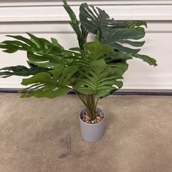 Small artificial decorative plant with vase.