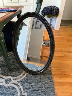 Black oval mirror