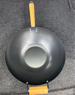 our table Large 14 in. Black Carbon Steel Non-Stick Gas Wok with Wook Handles