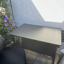 Black drafting table with small blemishes