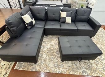 Black leather sectional couch and ottoman