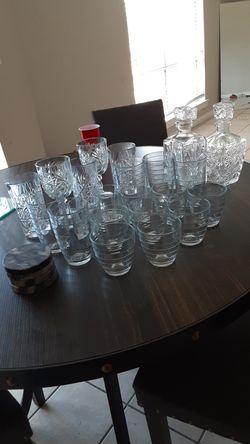 Glass cups with 2 bottles and 4 cups stands for the tables