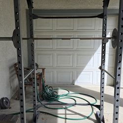 Power rack with Olympic bar and weight