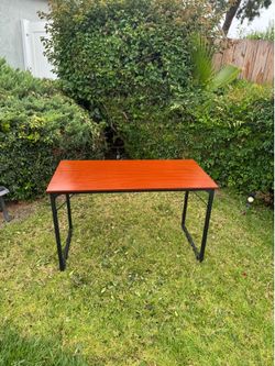 Wood top black metal leg table