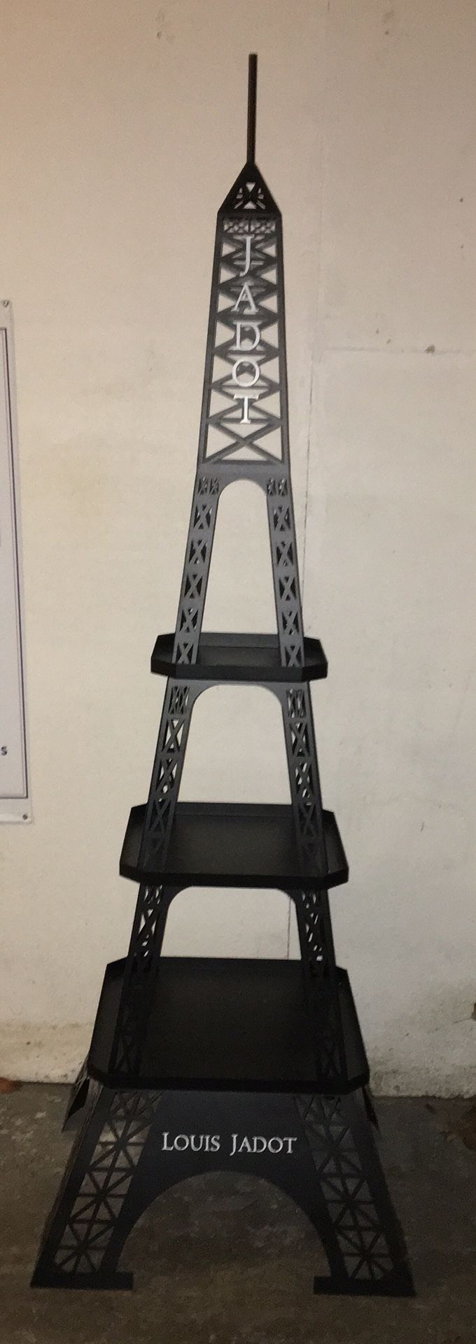 Louis Jadot Wine Eiffel Tower Display. This is metal and stands 6’4” tall and is 24” wide at the bottom. This will look great in your wine cellar. Br