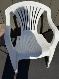 White plastic chair with arm rests