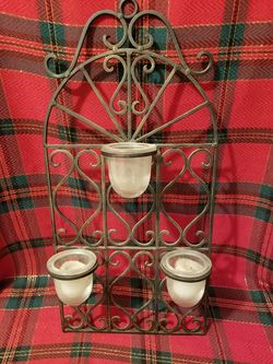 Vintage wrought iron wall mount candle holder.