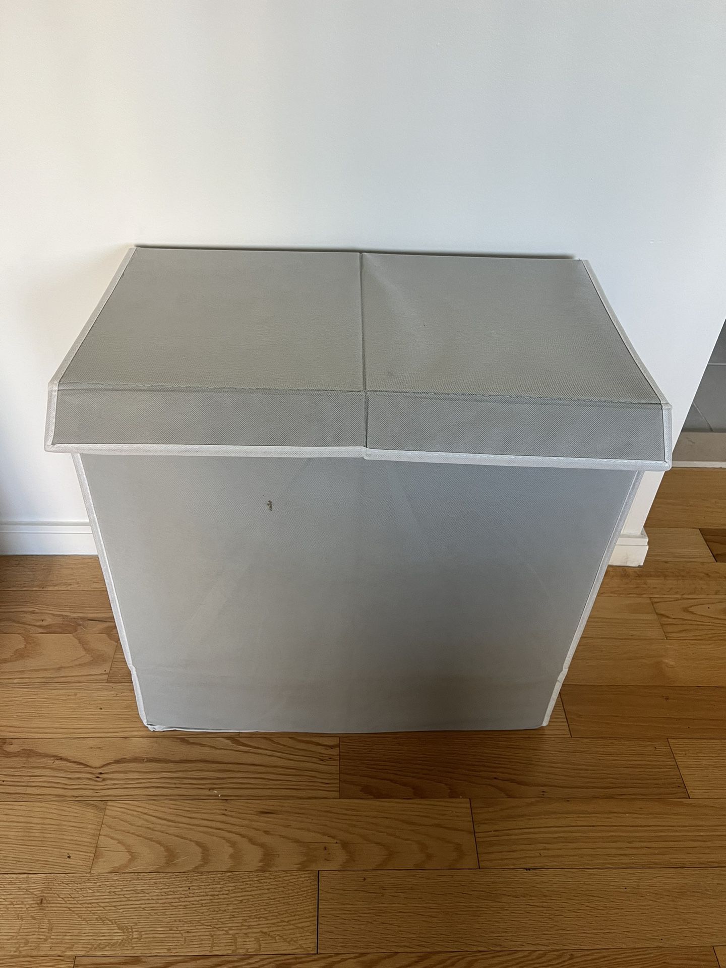 Double sided laundry hamper with lid