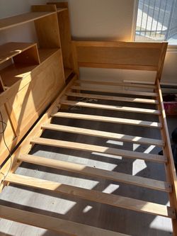 Wooden twin size bed frame with shelving