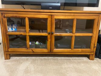 Wooden TV stand with glass doors