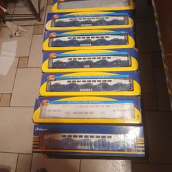 Lots of athearn bombardier cars coach car there 7 of the and 3 control car including a coaster cab car with parts on it the 3 coach car needs new pain