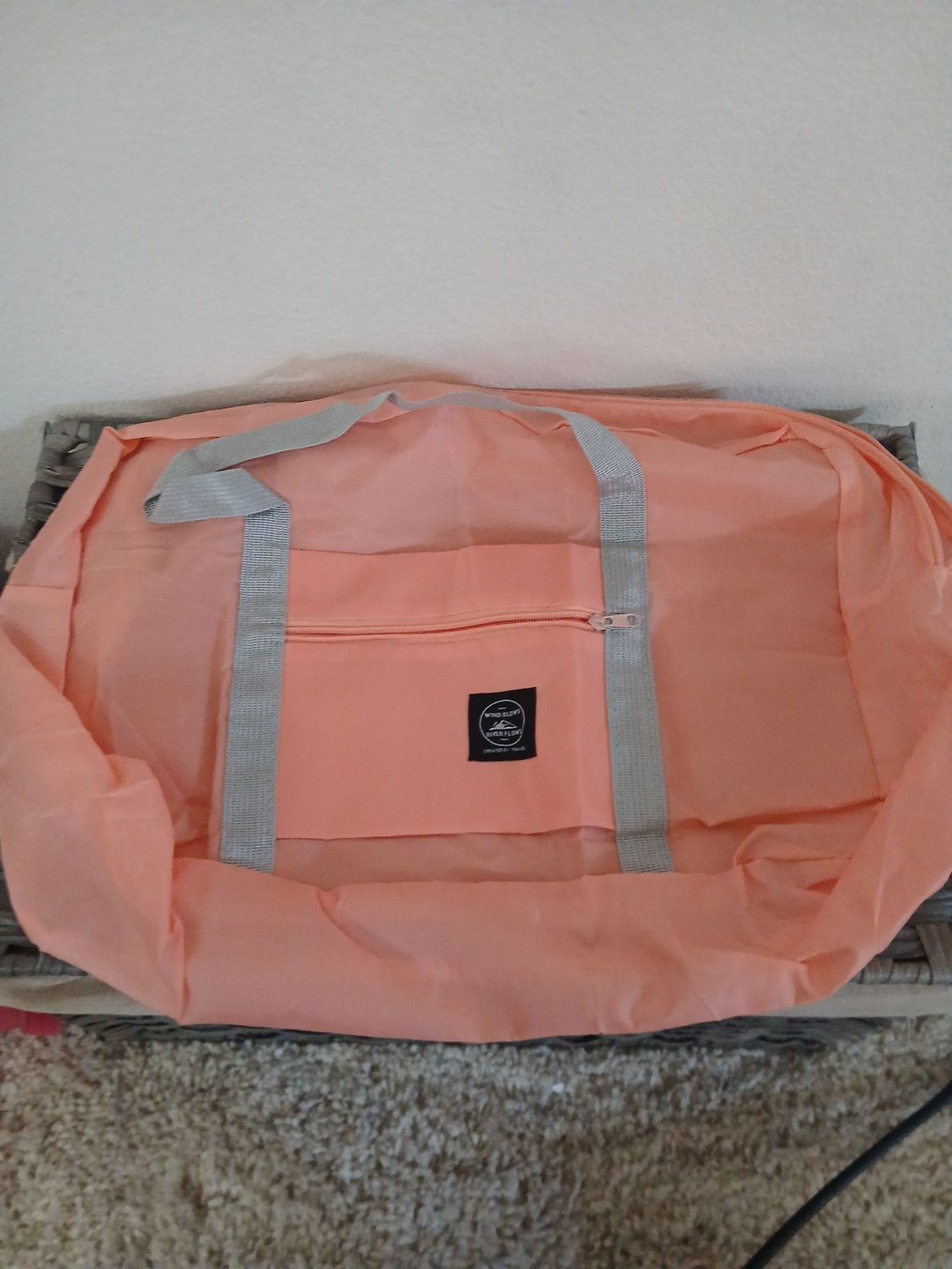 Wind blows river flows bag by travel in salmon pink color