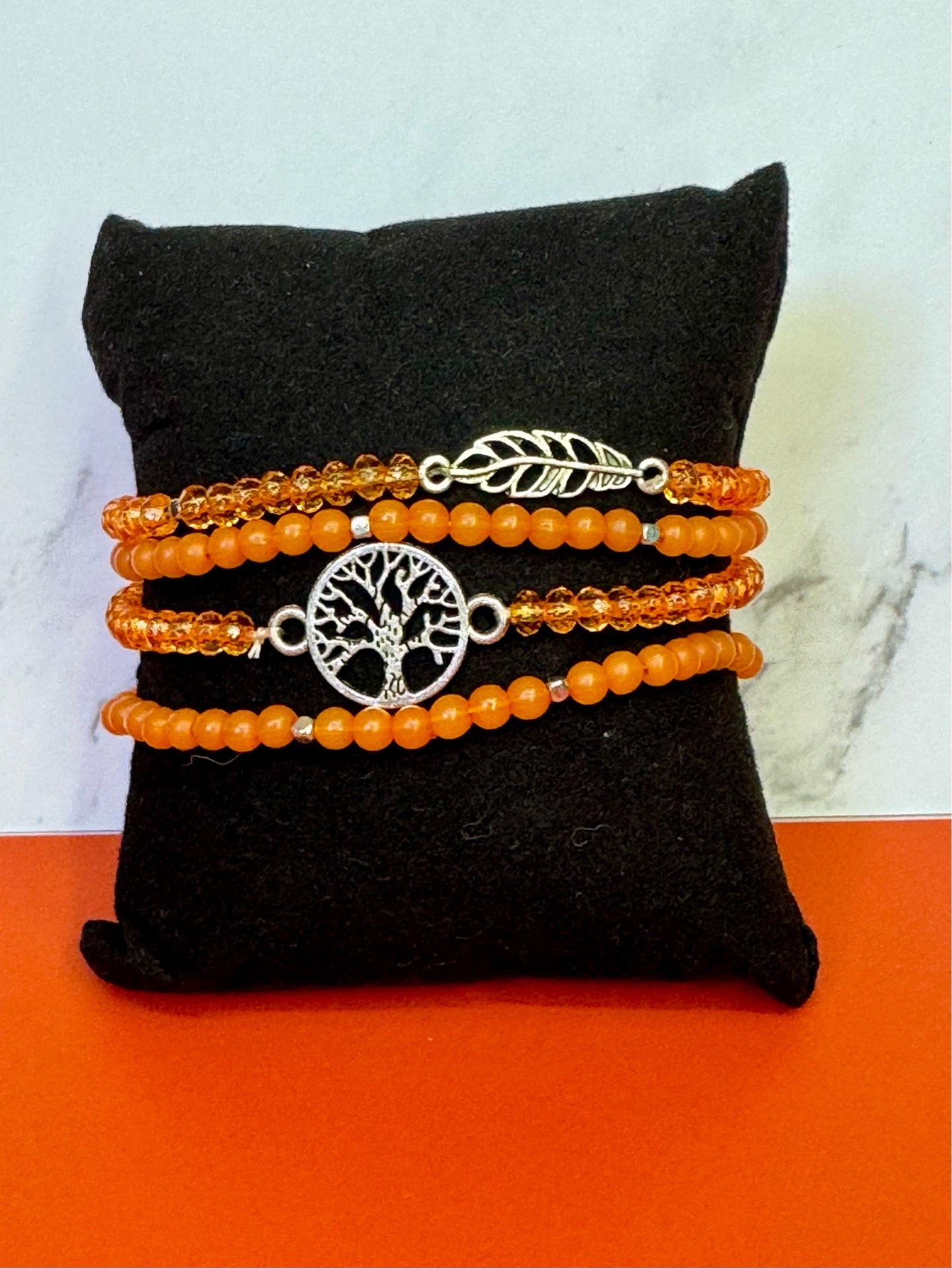 Orange Beaded Bracelet with Tree and feather charm