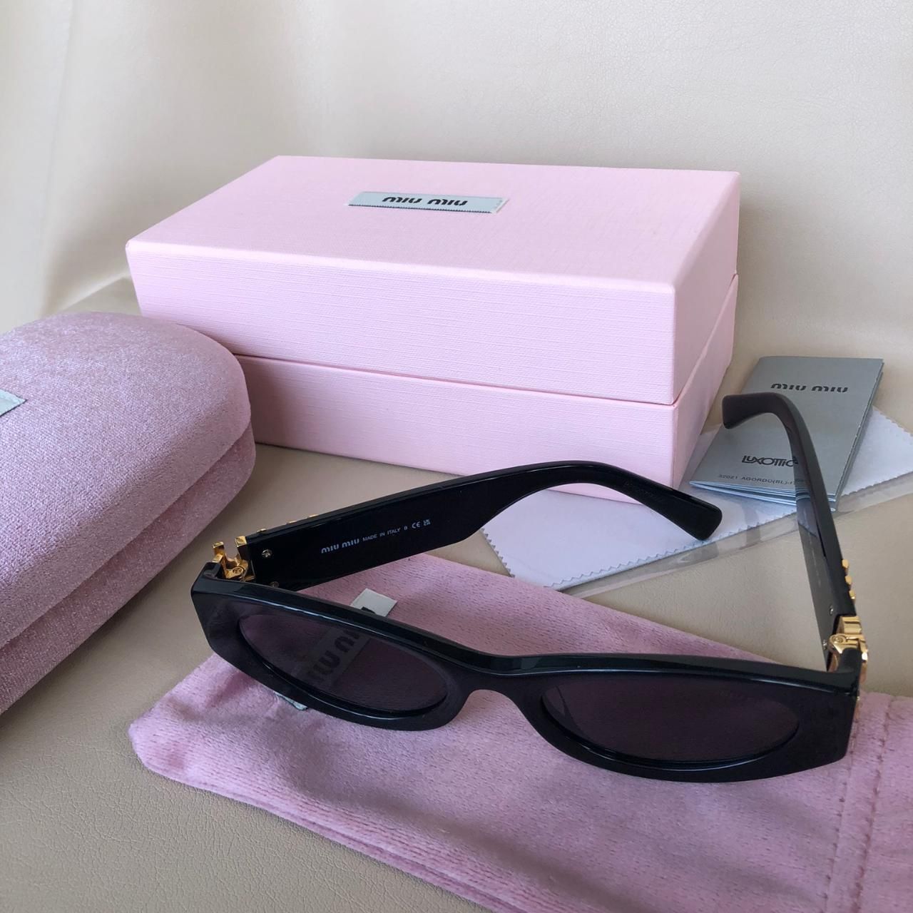 Miu Miu Women's Black and Gold Sunglasses