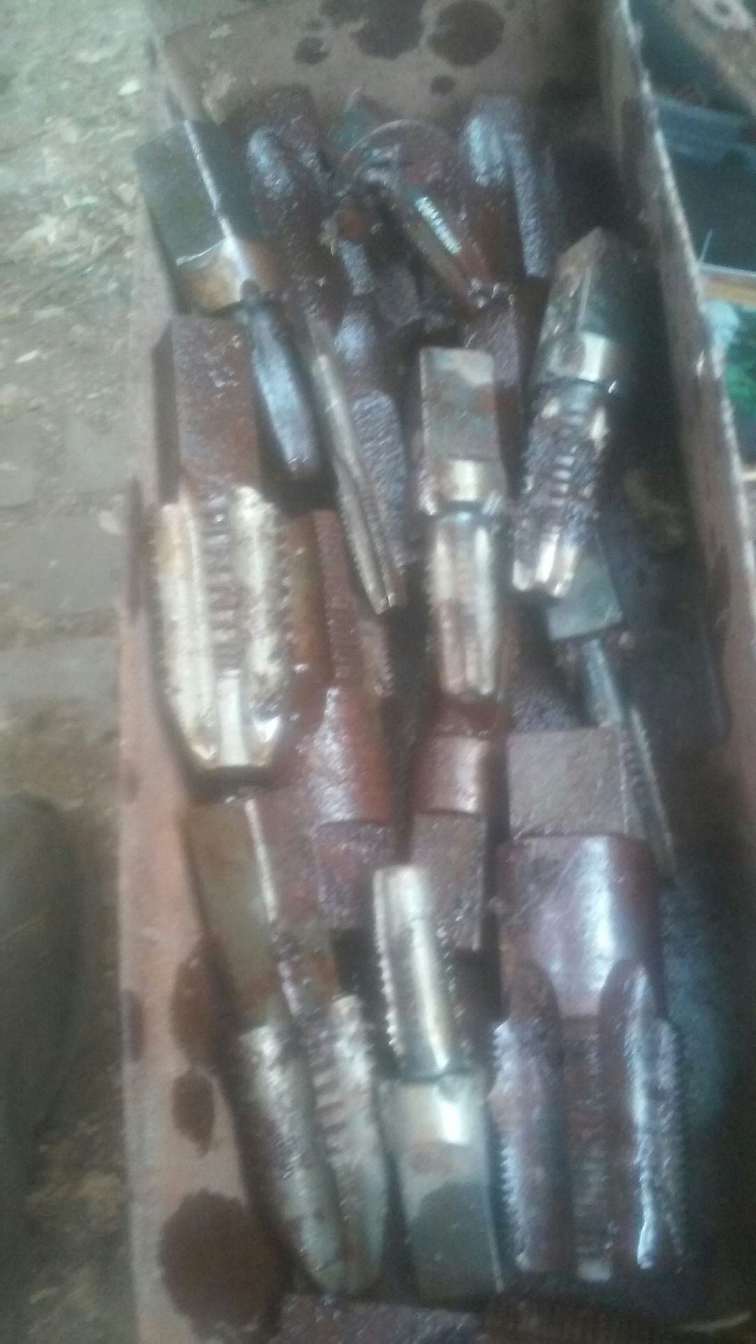 Tote box full of large taps and medium