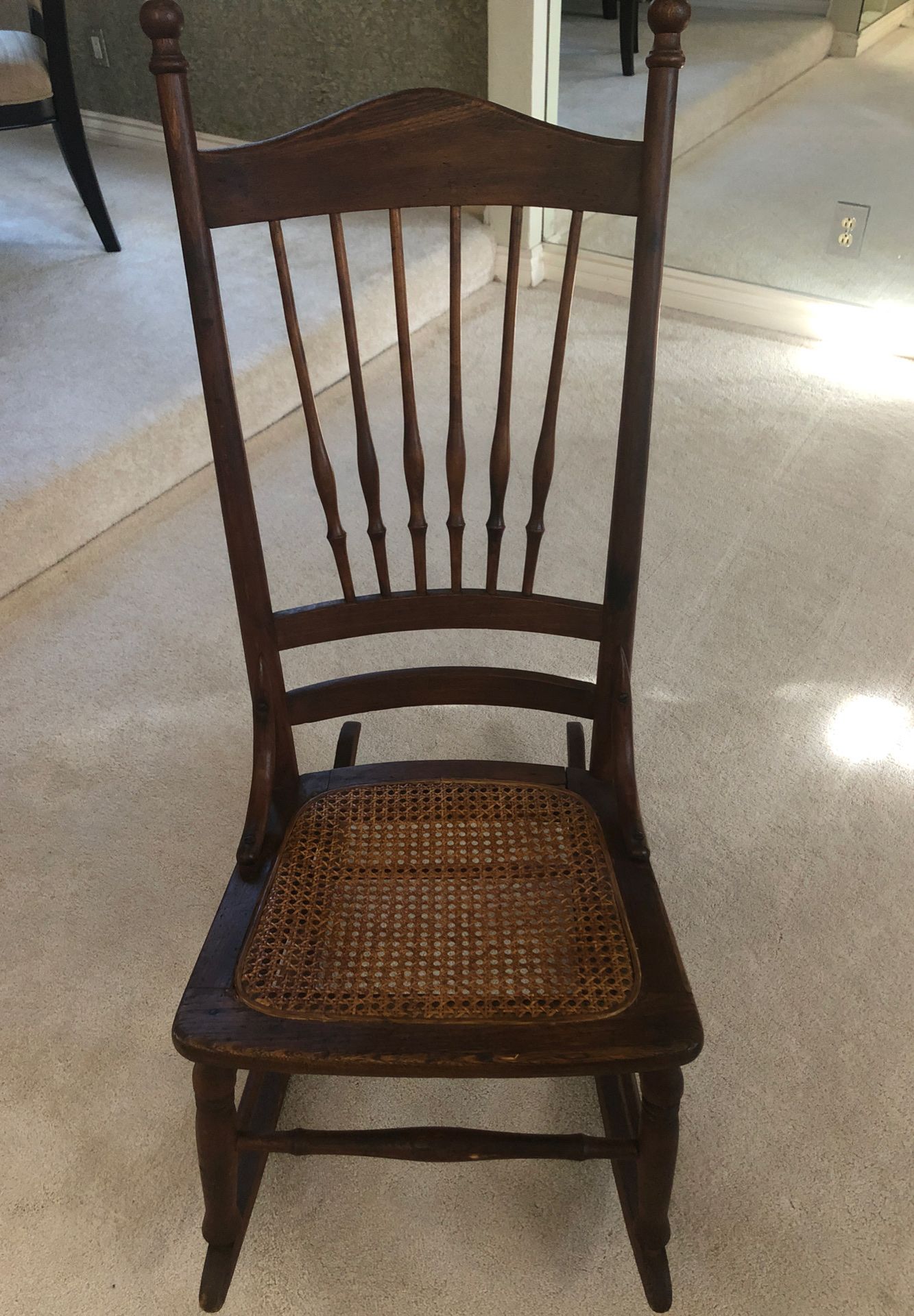 Antique oak rocking chair with cane seat. Circa 1900.