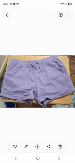 Women pull on purple shorts