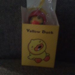 A Yellow Duck With Propeller Hat On Top