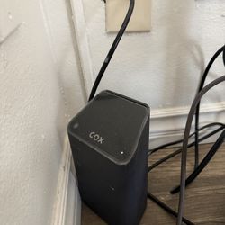 Functional Cox internet modem. Black color. Has power and coaxial cable ports. Good for getting your internet set up.